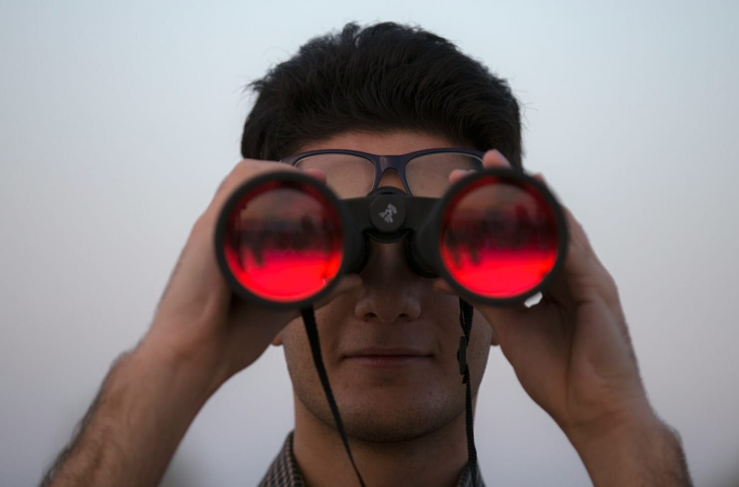 person holding black binoculars